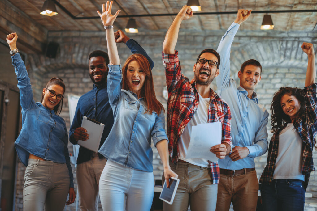 Diversity inclusion technology concept. Young hipster office workers punch air together.